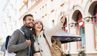 Beautiful happy couple autumn portrait. Young joyful smiling wom